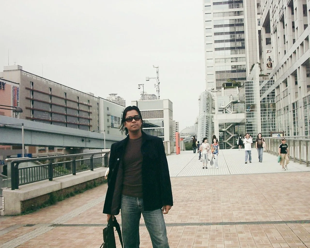 Dholi Baba standing on a broad city walkway while travelling