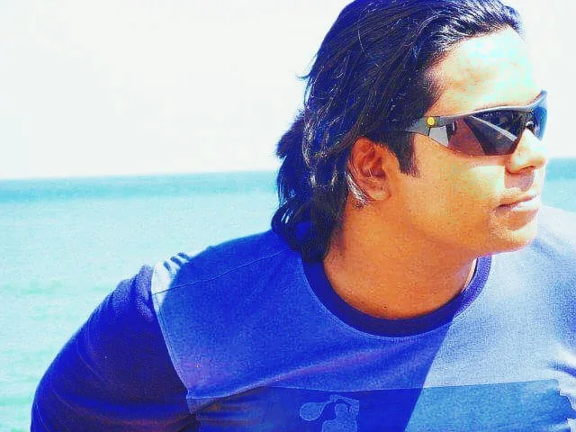 Dholi Baba in sunglasses beside the sea