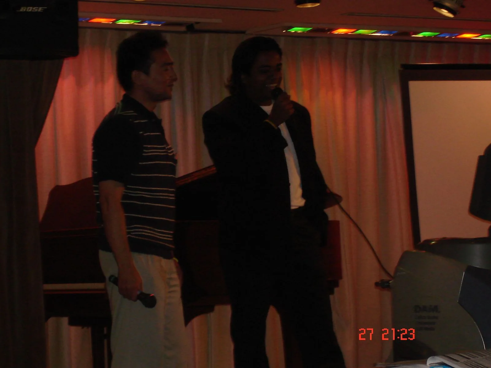 Dholi Baba holding a microphone on a small stage